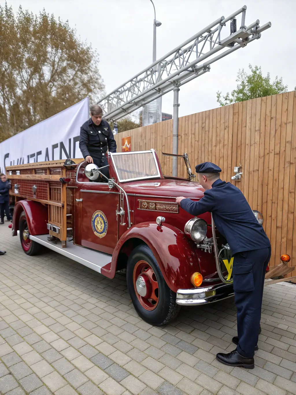 A photograph of a vintage fire engine, restored to its original condition, displayed at a local heritage fair. The image captures the engine's intricate details and the crowd's interest.